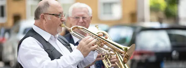 Zwei Musiker spielen Trompeten. Vielleicht spielen sie eines der meistgespielten Lieder bei Beerdigungen in Deutschland.