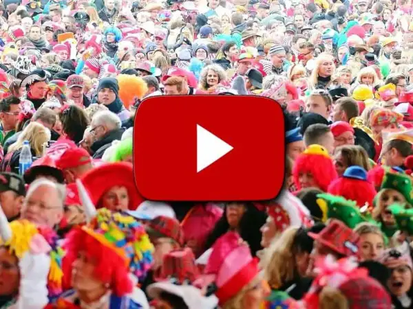 Bunte Kostüme und fröhliche Gesichter bei einem Karnevalsumzug. Hier gibt es die besten Karneval Lieder zum Mitsingen!